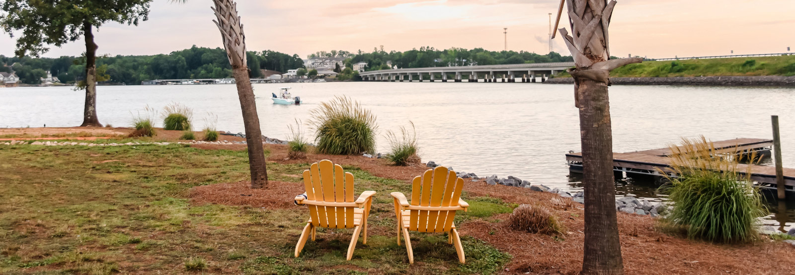 two outdoor chairs facing a lake